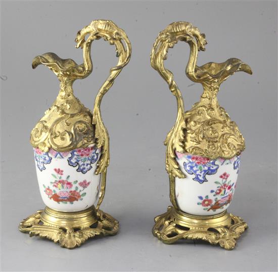 A pair of Chinese export porcelain and French ormolu mounted ewers, 22.5cm high, porcelain damaged